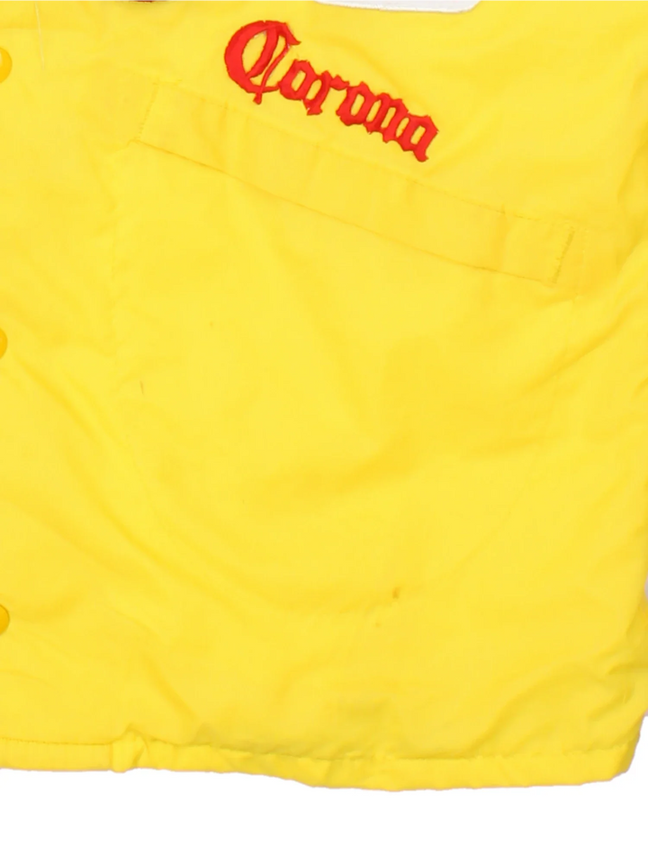 70's Vintage Coach Jacket in a yellow/multi colourway. Button popper fastening with front pockets, elasticated cuffs and hem with brushed lining. Embroidered patches and logos on front and back.