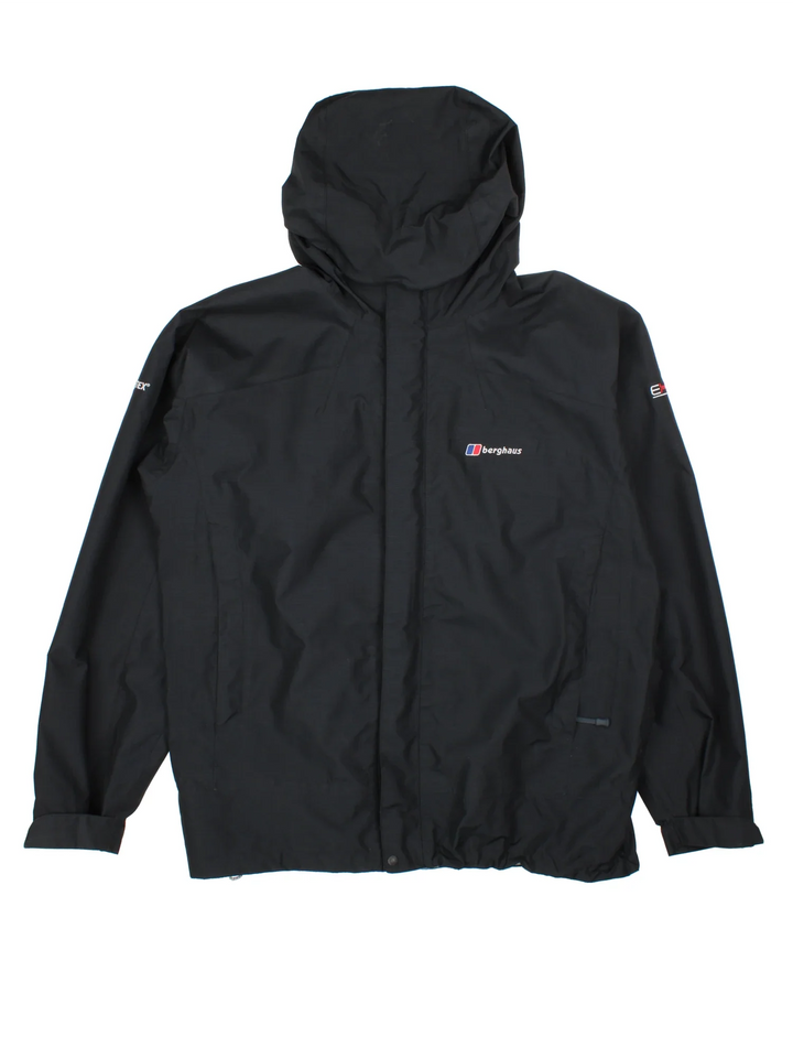 Berghaus Hilwalker Jacket in a black colourway. Full button and zip up front with multiple pockets, drawstring hood and small logo on the front pocket.