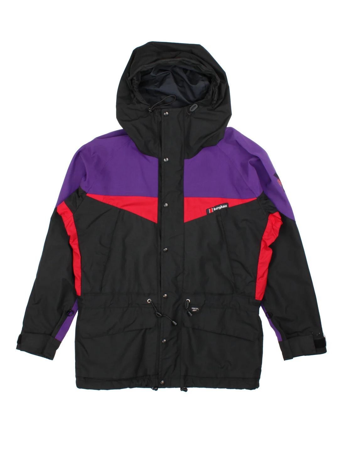 Berghaus Trango Extrem 7000 Jacket in a black colourway with purple and red panelling. Full button and zip up front with multiple pockets, drawstring hood and small logo on the front.