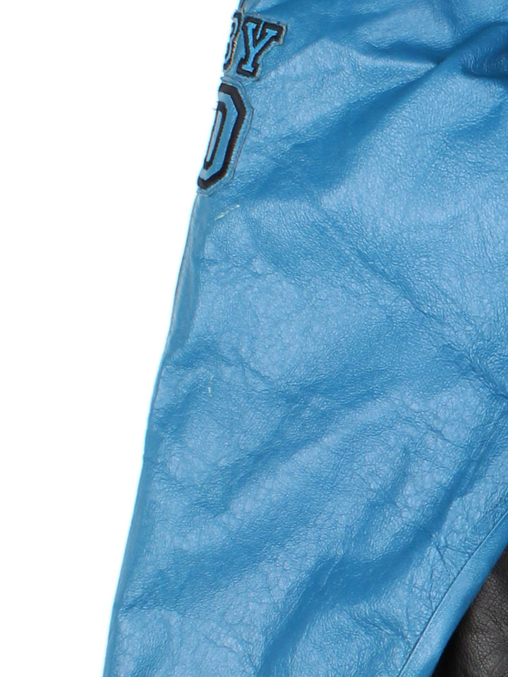 Vintage Scooby-Do Wear R U? Leather Varsity Jacket in a black and blue colourway. Zips up and has side pockets, and the spell out and character graphic embroidered on the front and back.