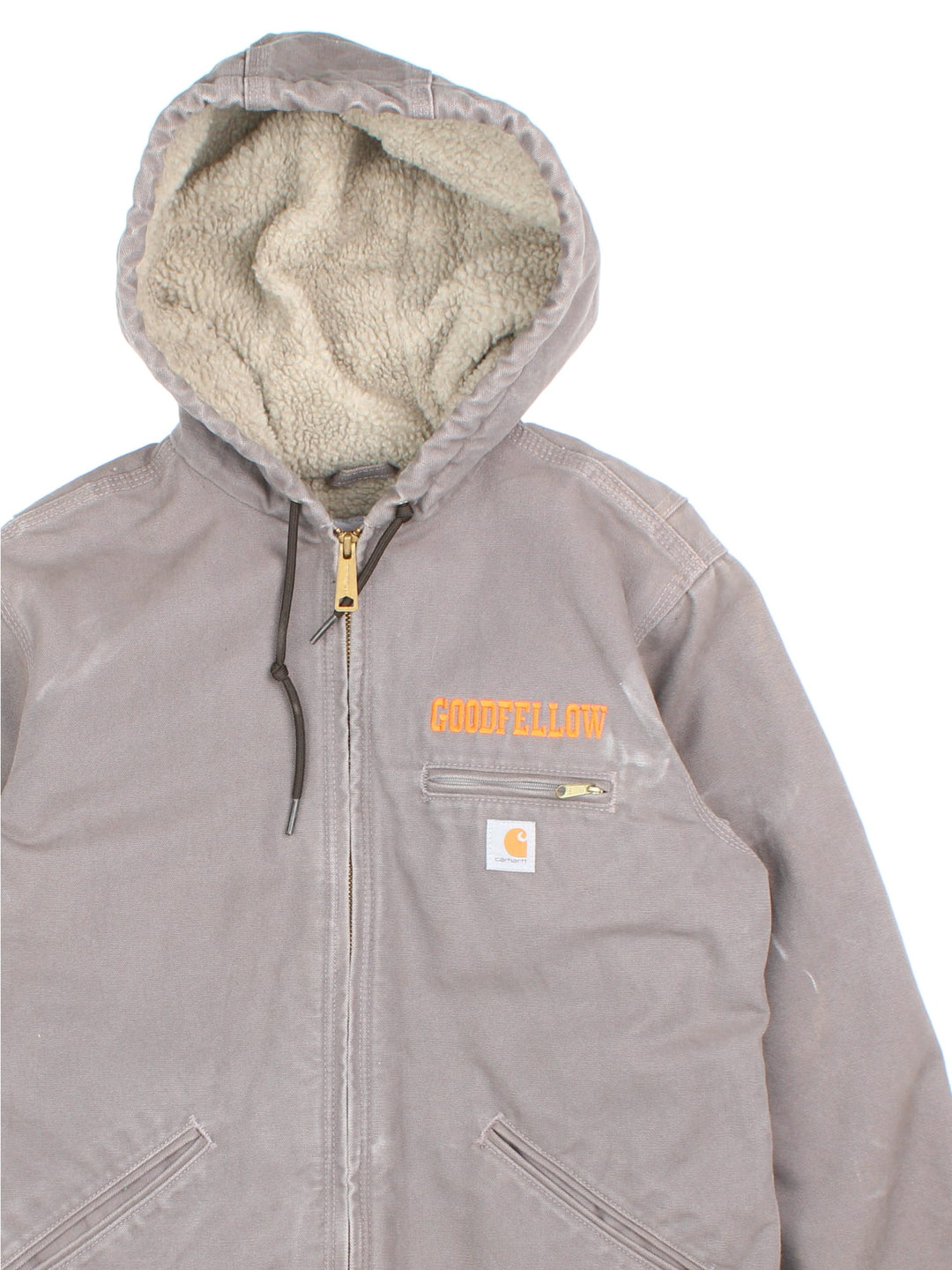 Carhartt Jacket in a grey colourway. Zips up and has multiple pockets, insulated with a sherpa lining, and has the logo and 'Goodfellow' logo embroidered on the front.