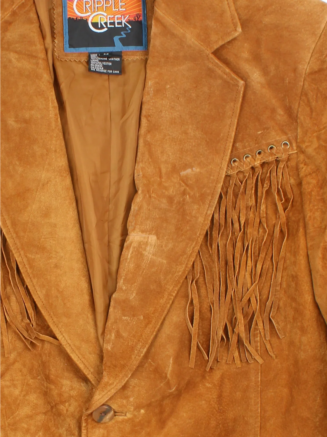Vintage Western Fringed Leather Jacket in a tan colourway. Button fastening, with front pockets and fringe detail.