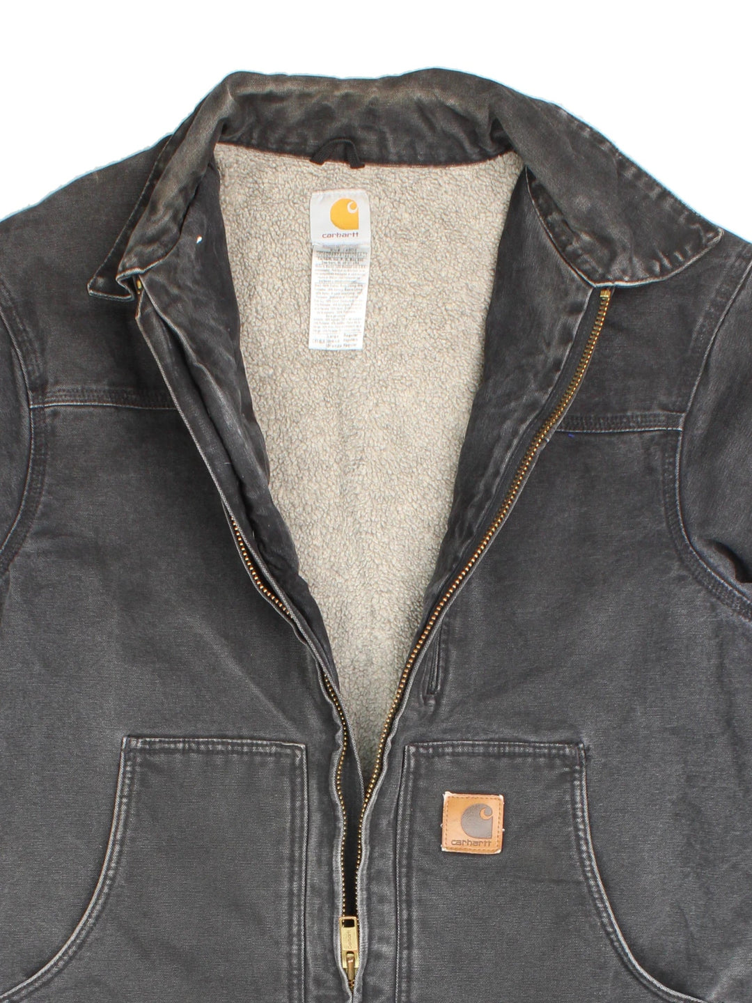 Vintage Carhartt Arctic Jacket in a black colourway. Zips up and has side pockets, insulated with a fleece lining, and has leather logo on the front.
