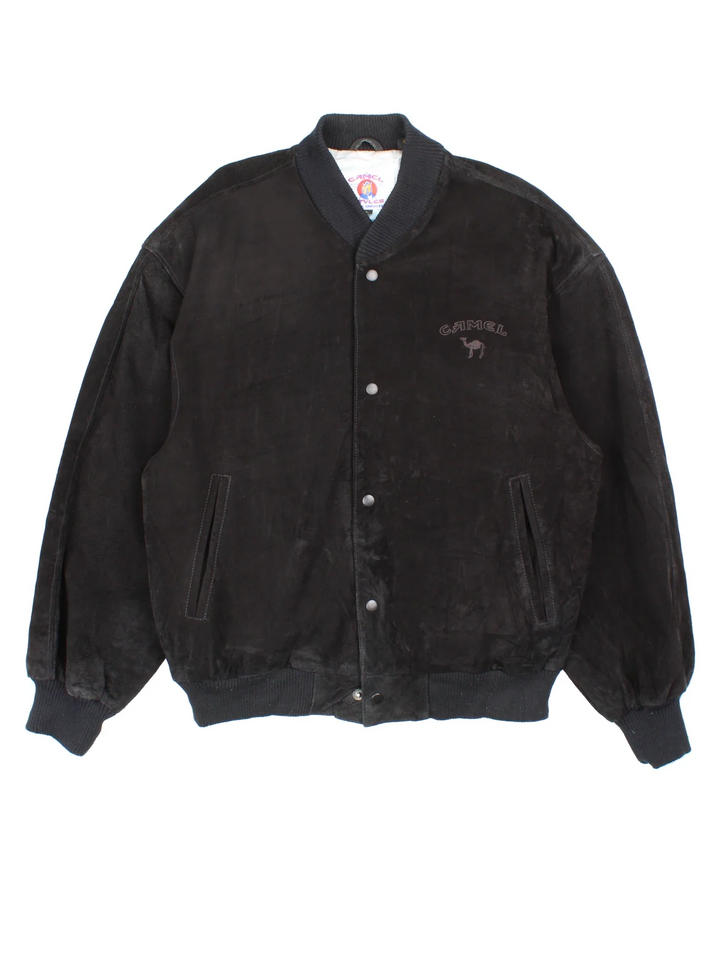 Vintage 90's Camel Suede Bomber Jacket in a black colourway. Buttons up and has side pockets, insulated with a satin lining, and has the logo embroidered on the front.
