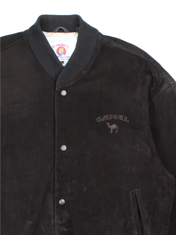 Vintage 90's Camel Suede Bomber Jacket in a black colourway. Buttons up and has side pockets, insulated with a satin lining, and has the logo embroidered on the front.