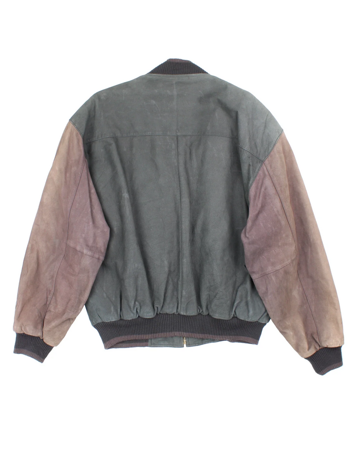 Vintage 90's Members Only Leather Bomber Jacket in a brown colourway. Zips up and has side pockets, insulated with a quilted lining, and has elasticated cuffs and hems.