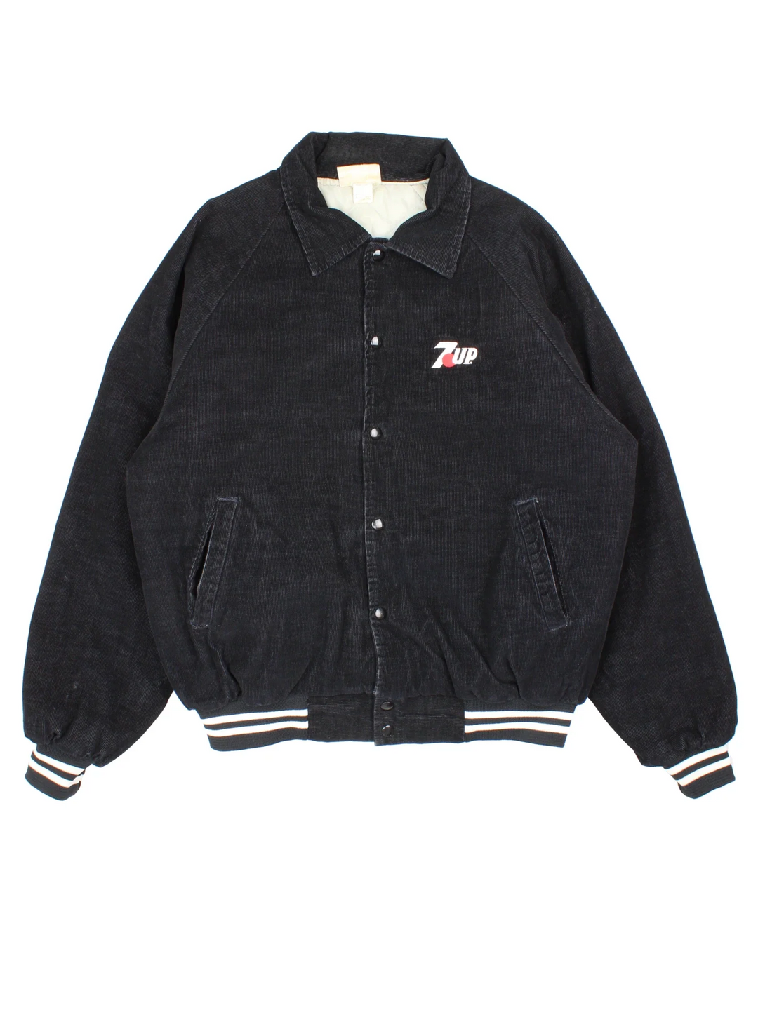 Vintage 1980's 7up Corduroy Jacket in a black colourway. Buttons up and has side pockets, insulated with a quilted lining, and has the logo embroidered on the front.