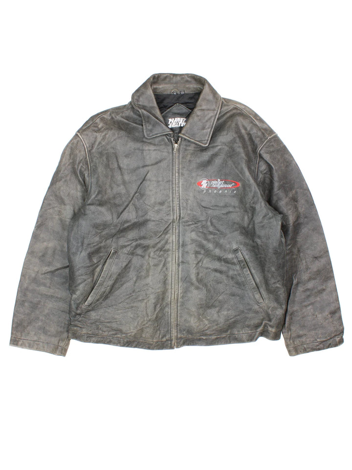 Vintage 90's Planet Hollywood Leather Jacket in a grey colourway. Zips up and has side pockets, insulated with a quilted lining, and has the logo embroidered on the front.