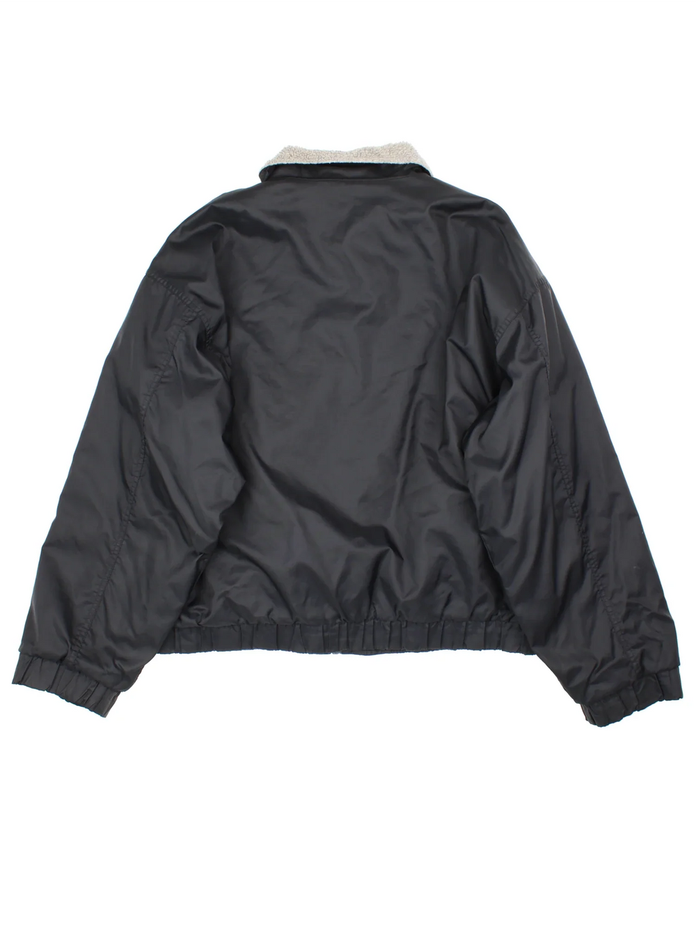 90's Nike Bomber Jacket in a black colourway. Zips up and has side pockets, insulated with a fleece lining, and has the swoosh logo embroidered on the front.