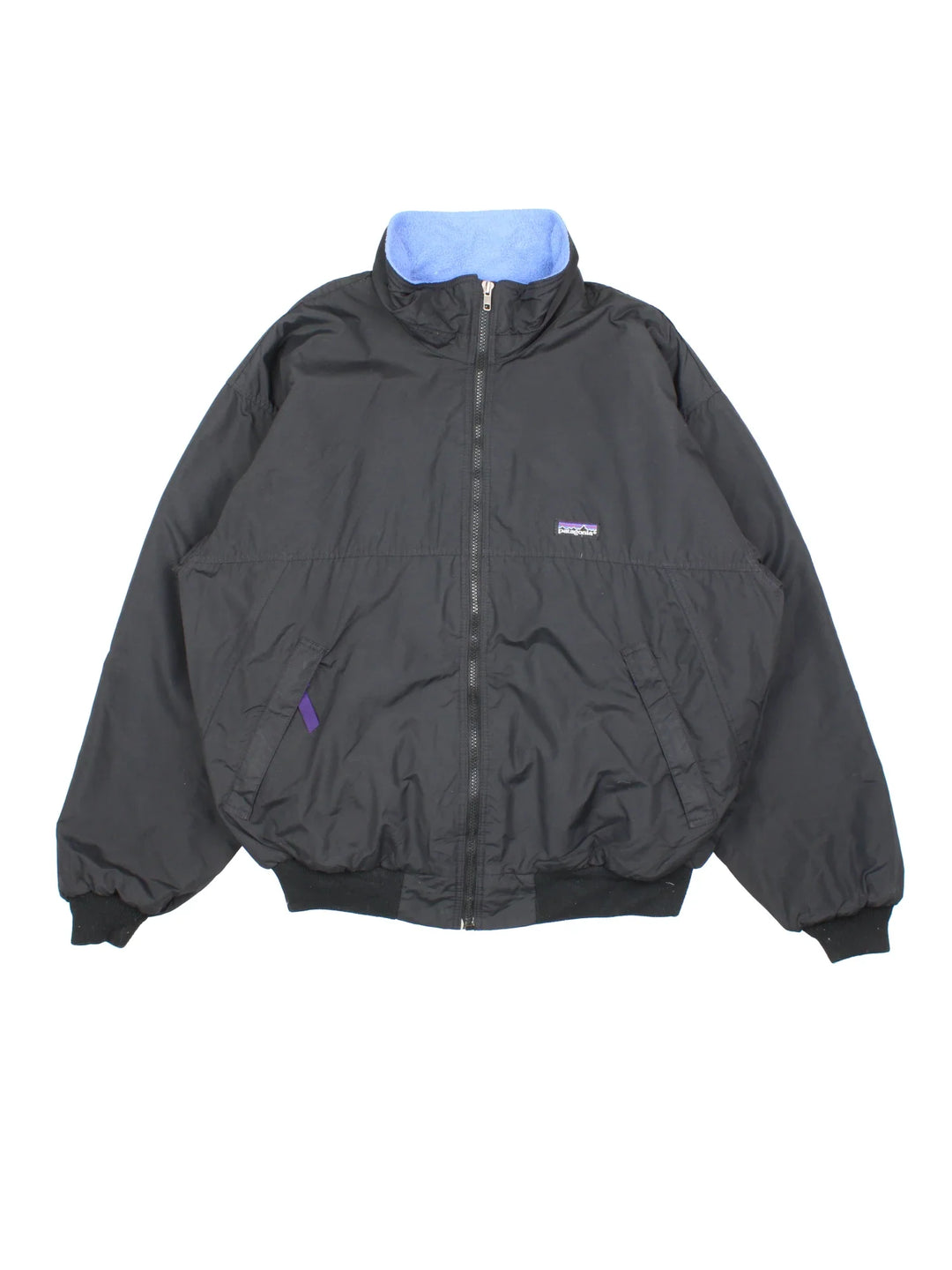 Vintage Patagonia Fleece Lined Jacket in a black colourway with blue fleece lining. Full zip up and has side pockets and small classic logo on the front.