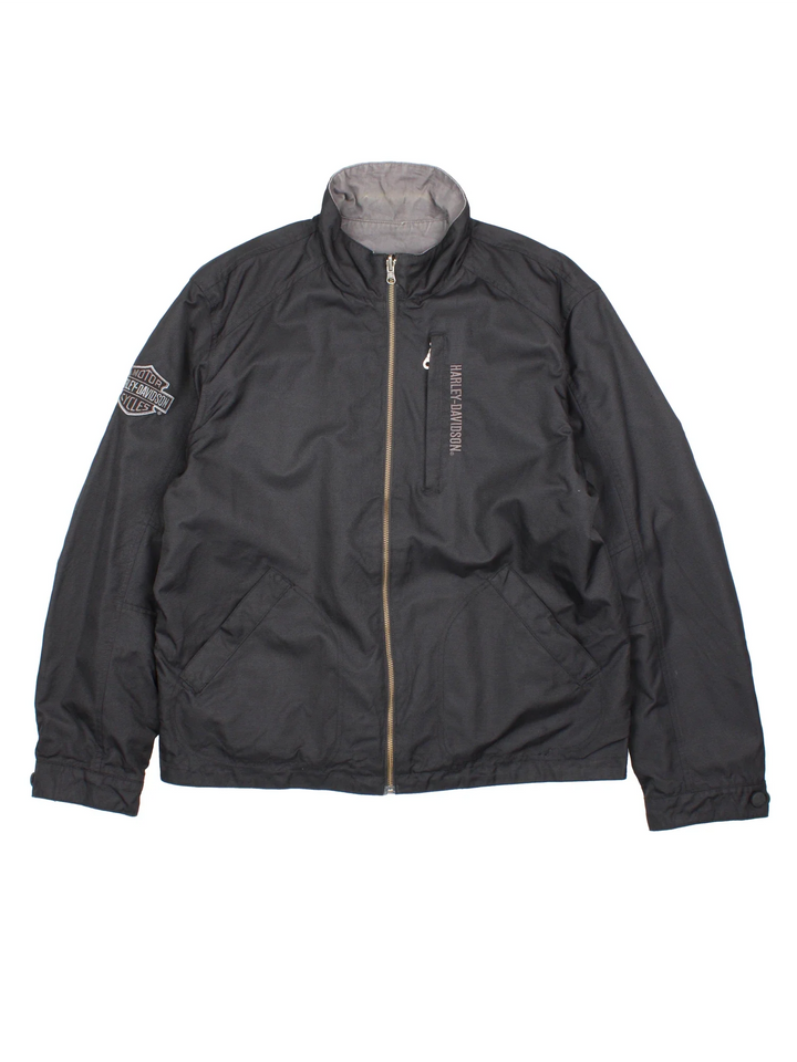 Harley-Davidson Jacket in a black colourway with grey revesible side. Full zip up, multiple pockets and large graphic on the back and brand logo.