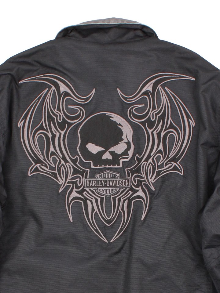 Harley-Davidson Jacket in a black colourway with grey revesible side. Full zip up, multiple pockets and large graphic on the back and brand logo.