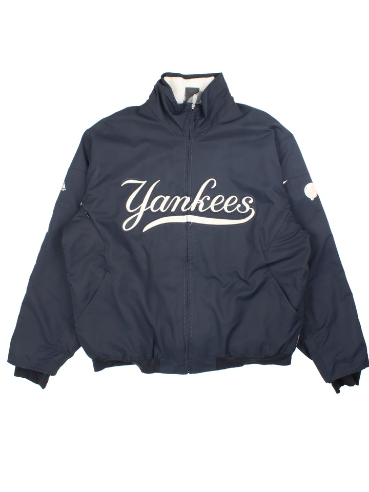 MLB New York Yankees Light Jacket in a blue colourway with full zip up and large text logo across the front. Fleece lining inside and around the collar. Small MLB logo on the back neck.