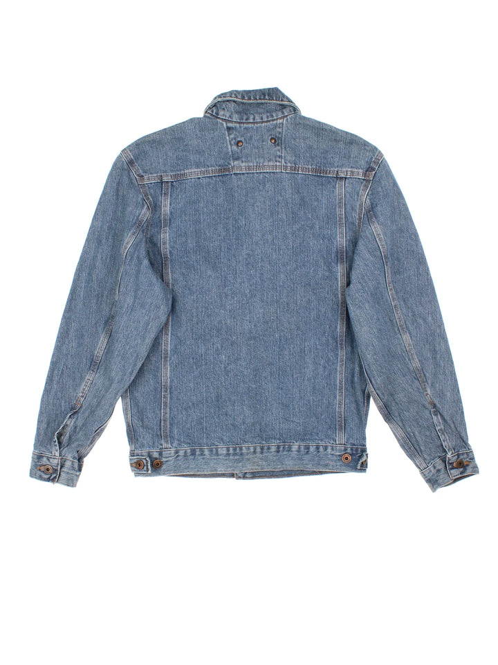 Carhartt Denim Jacket in a blue colourway with button up front, multiple pockets and small classic logo on the front.
