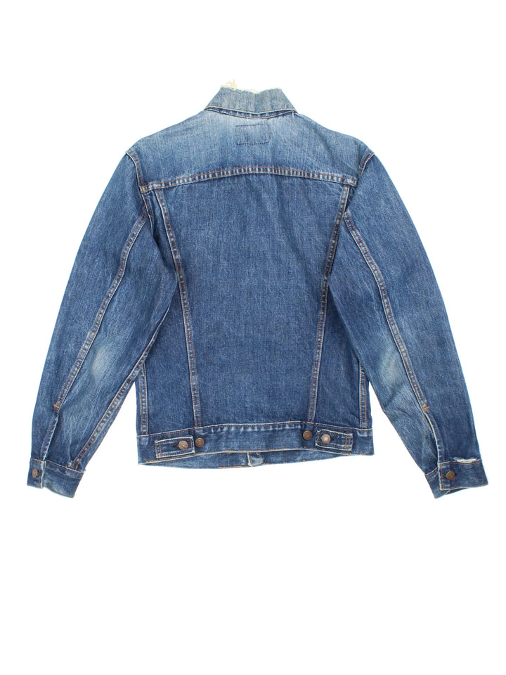 Vintage Levi Strauss Denim Jacket in a blue colourway. Buttons up and has double chest pockets, and the logo tab embroidered on the front.
