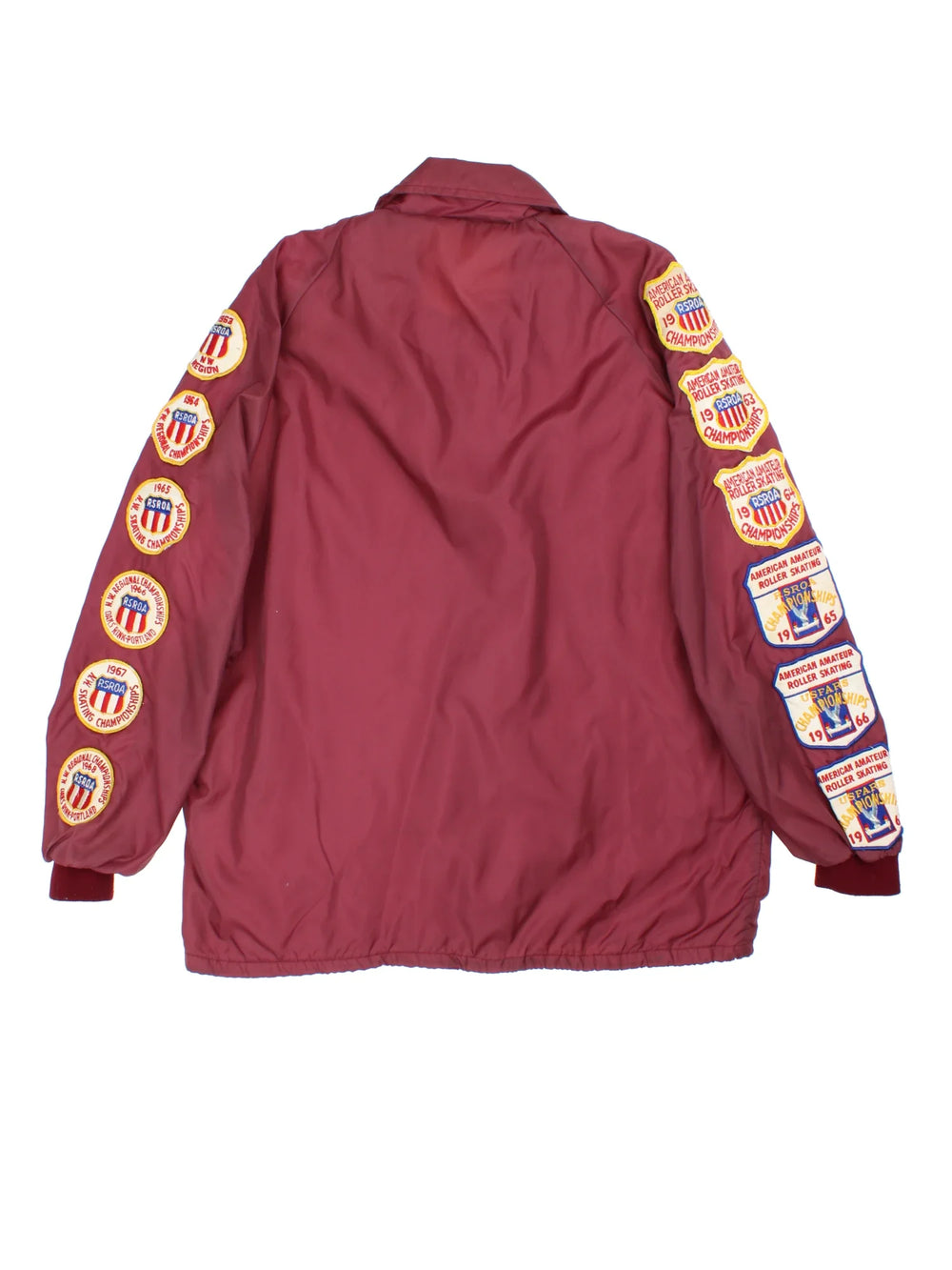 Vintage 1960's Roller Skating Champion Patch Coach Jacket in a red colourway. Buttons up and has side pockets, and patchwork badges embroidered on the front and sleeves.