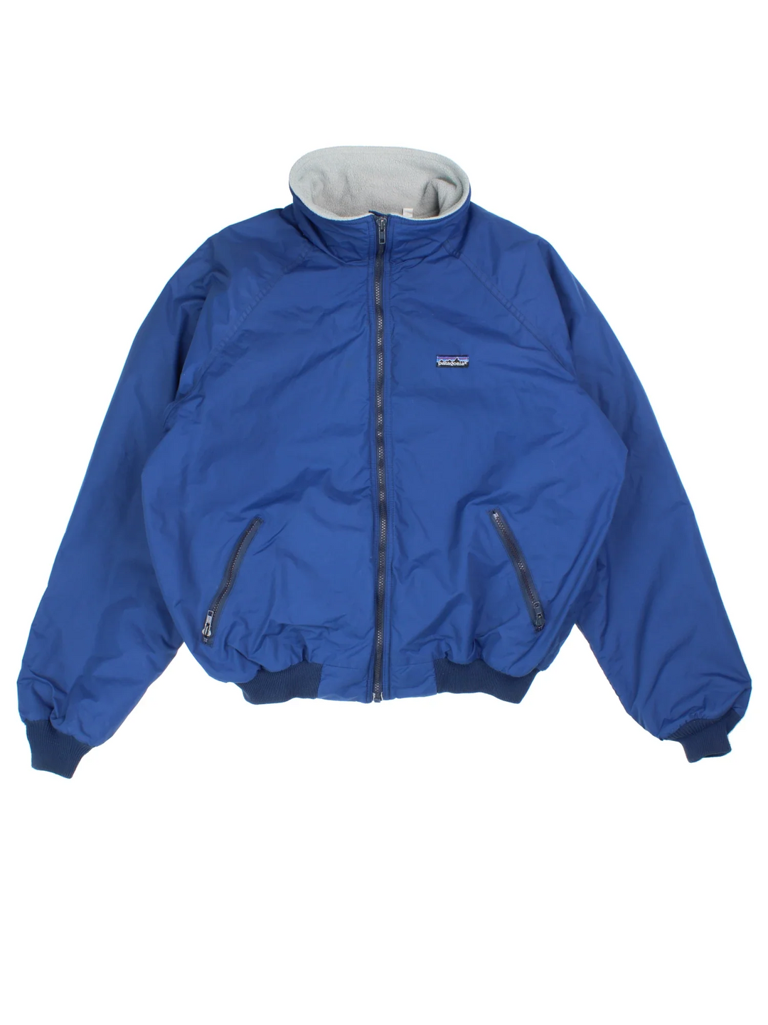 Vintage 90's Patagonia Fleece Lined Bomber Jacket in a blue colourway. Zip fastening, with side pockets, fleece lining and has the logo embroidered on the front.