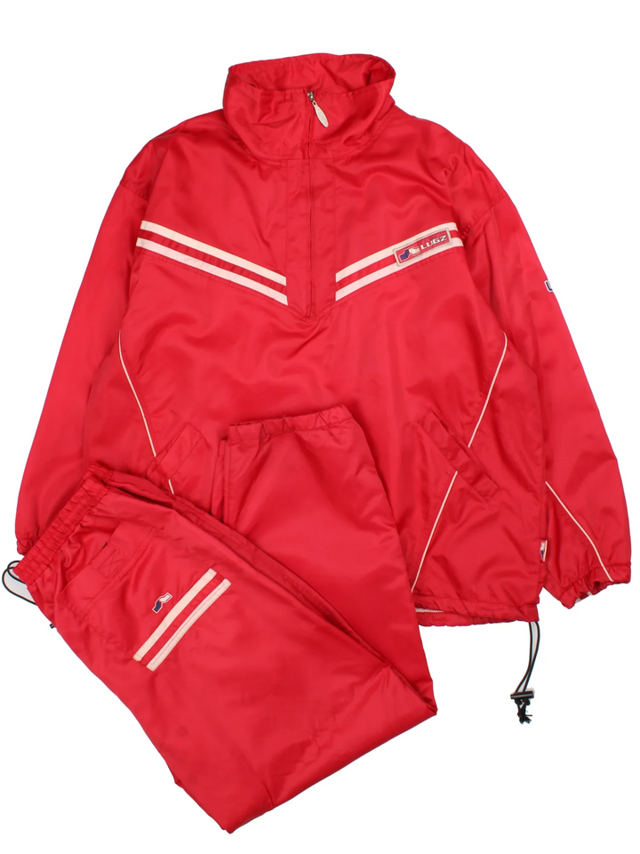 Vintage Lugz Shell Suit Jacket & Pants Set in a red colourway. Jacket has half zip up closure, side pockets, and the logo embroidered on the front and larger on the back. Pants have an elasticated waist with drawstring, pockets, mesh lining and the logo embroidered on the front and back