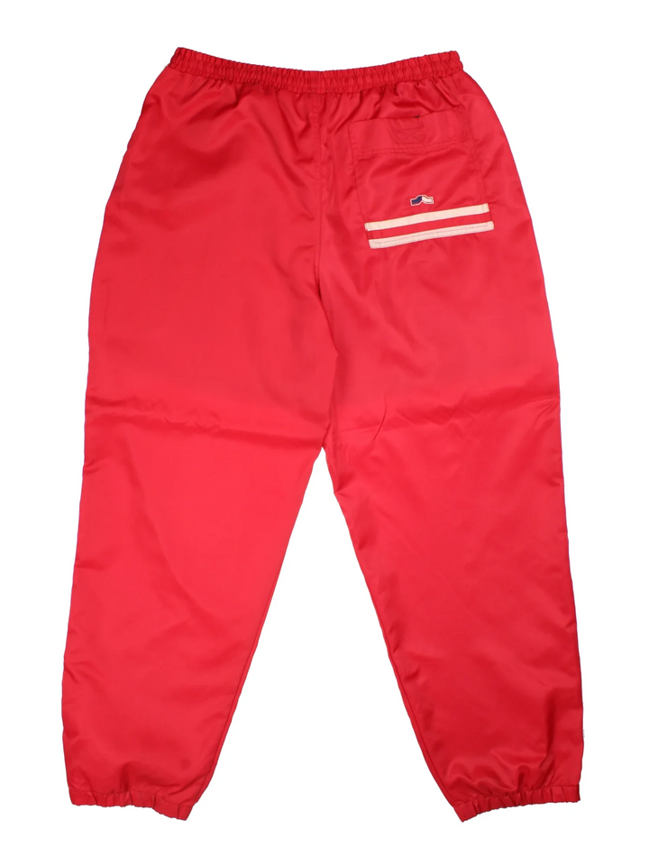 Vintage Lugz Shell Suit Jacket & Pants Set in a red colourway. Jacket has half zip up closure, side pockets, and the logo embroidered on the front and larger on the back. Pants have an elasticated waist with drawstring, pockets, mesh lining and the logo embroidered on the front and back