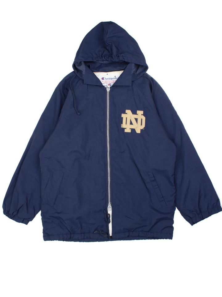 Vintage 90's Champion Notre Dame Water Polo Sports Coat in a blue colourway. Zip up closure, has side pockets, insulated lining, hooded, and has the logo embroidered on the front and spell out on the back.