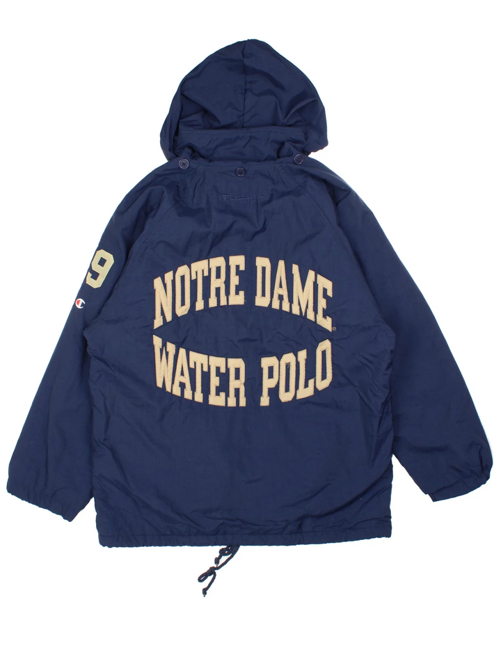 Vintage 90's Champion Notre Dame Water Polo Sports Coat in a blue colourway. Zip up closure, has side pockets, insulated lining, hooded, and has the logo embroidered on the front and spell out on the back.