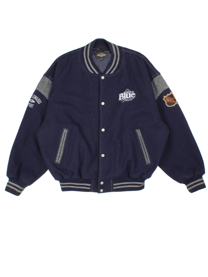 Vintage 90's Roger Edwards Sports Varsity Jacket in a blue colourway. Zip up closure, has side pockets, woollen with a insulated lining, and has the logos embroidered on the front and sleeves.