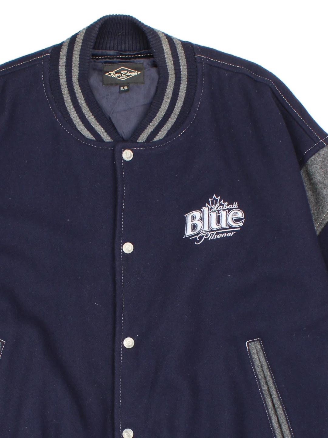 Vintage 90's Roger Edwards Sports Varsity Jacket in a blue colourway. Zip up closure, has side pockets, woollen with a insulated lining, and has the logos embroidered on the front and sleeves.