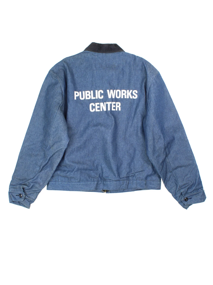 Vintage 80's Wrangler Big Ben Work Jacket in a blue colourway with a black corduroy collar. Zip up closure, has side pockets, blanket lining, and has 'Public Works Centre' spell out printed on the back.