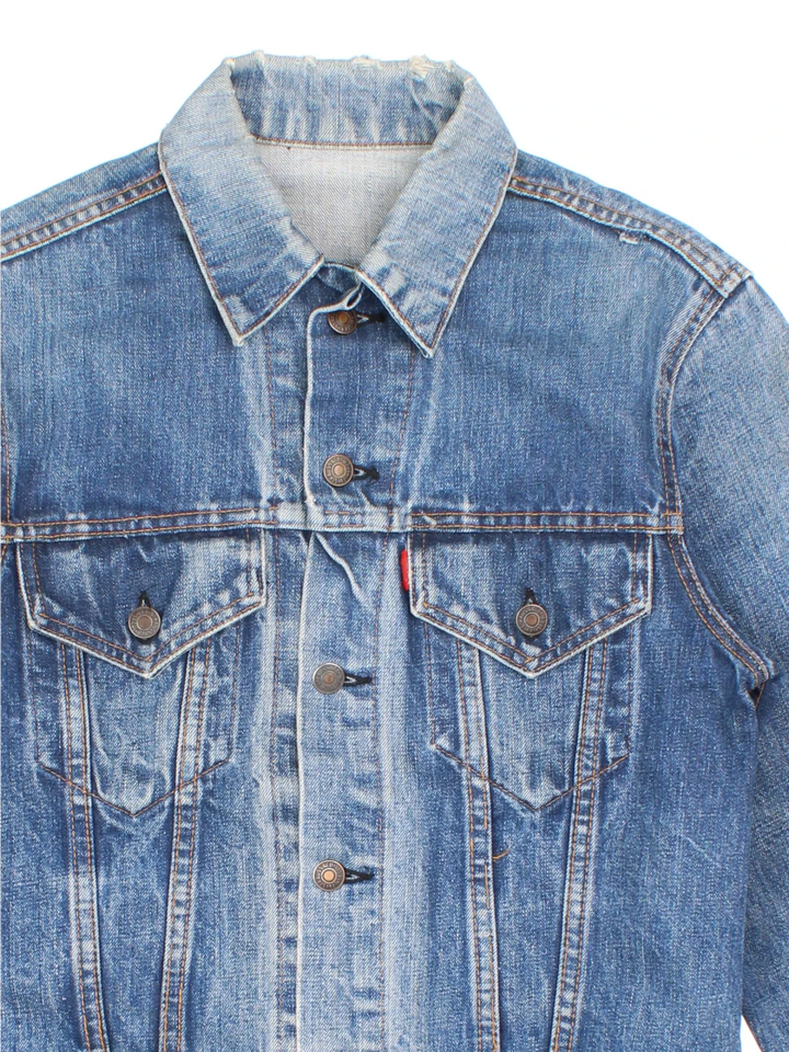 Vintage Levi Strauss Denim Jacket in a blue colourway. Buttons up and has double chest pockets, and the logo tab embroidered on the front.