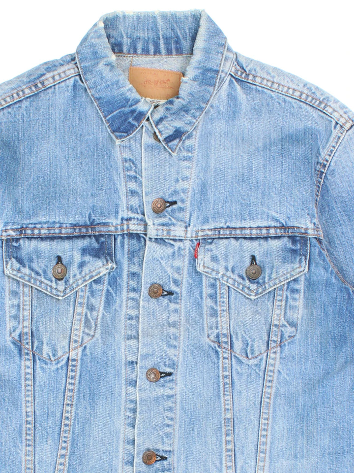 Vintage Levi Strauss Denim Jacket in a blue colourway. Buttons up and has double chest pockets, and the logo tab embroidered on the front.