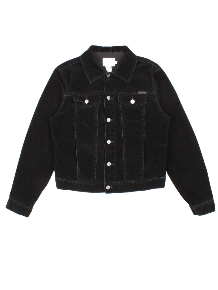 Calvin Klein Corduroy Jacket in a black colourway. Buttons up and has multiple pockets, and the logo tab embroidered on the front.
