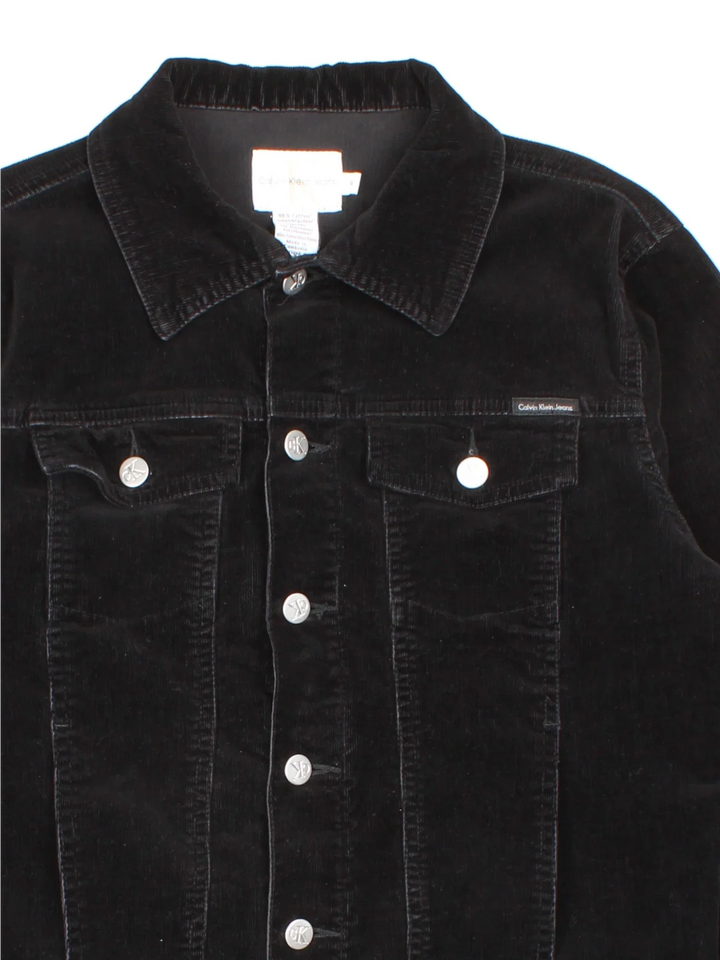 Calvin Klein Corduroy Jacket in a black colourway. Buttons up and has multiple pockets, and the logo tab embroidered on the front.
