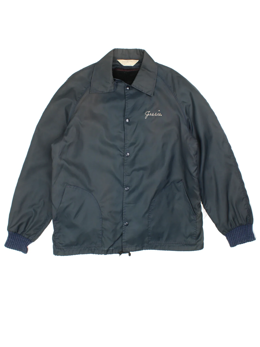 Vintage 1980's Fire Fighter Coach Jacket in a navy blue colourway. Zips up and has side pockets, detachable insulated fleece lining, and the logo embroidered on the back.