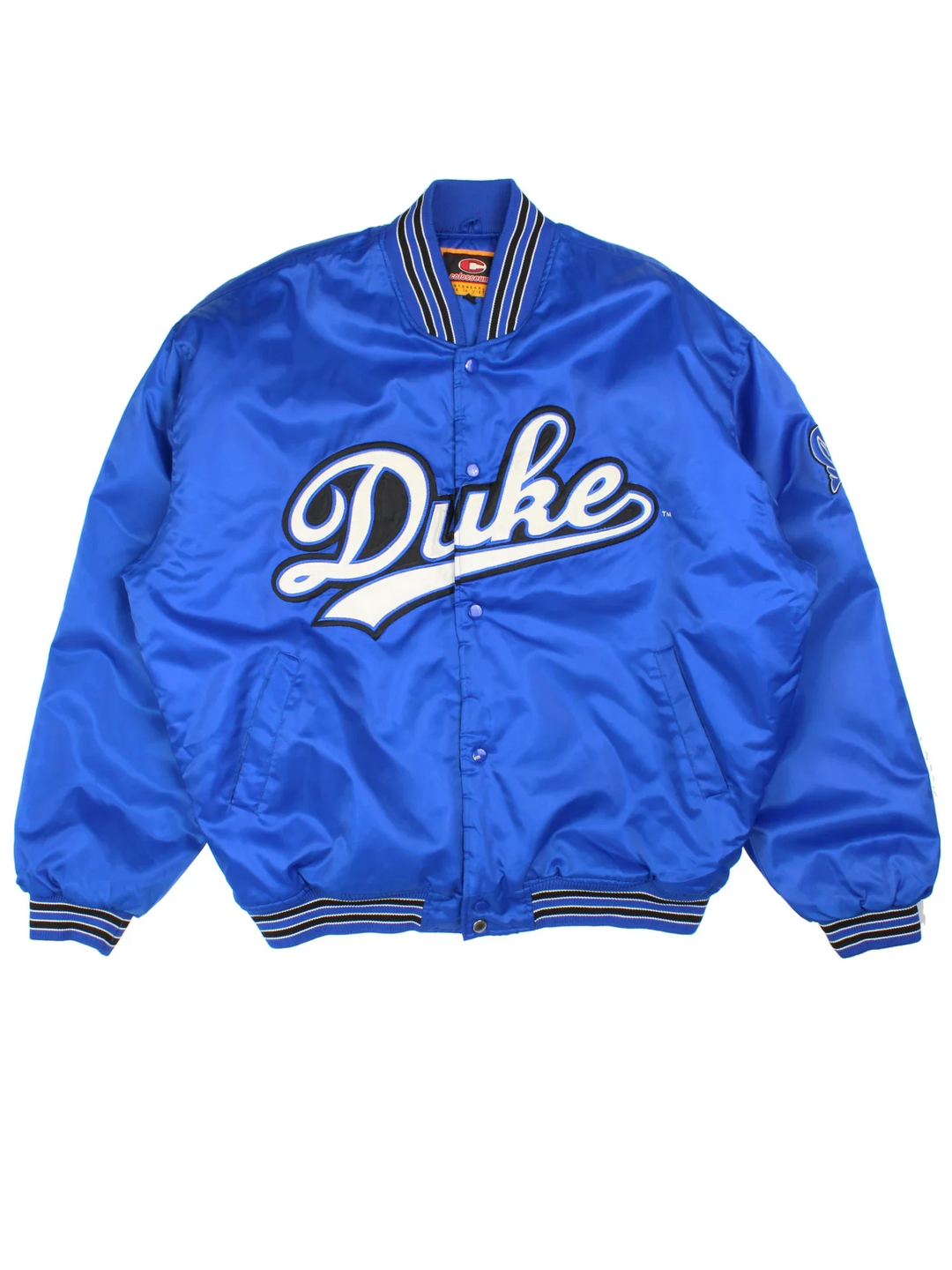 Vintage 90's Duke Blue Devils Varsity Jacket in a blue colourway. Buttons up and has side pockets, insulated lining, and the team spell out embroidered on the front and logo on the left sleeve.