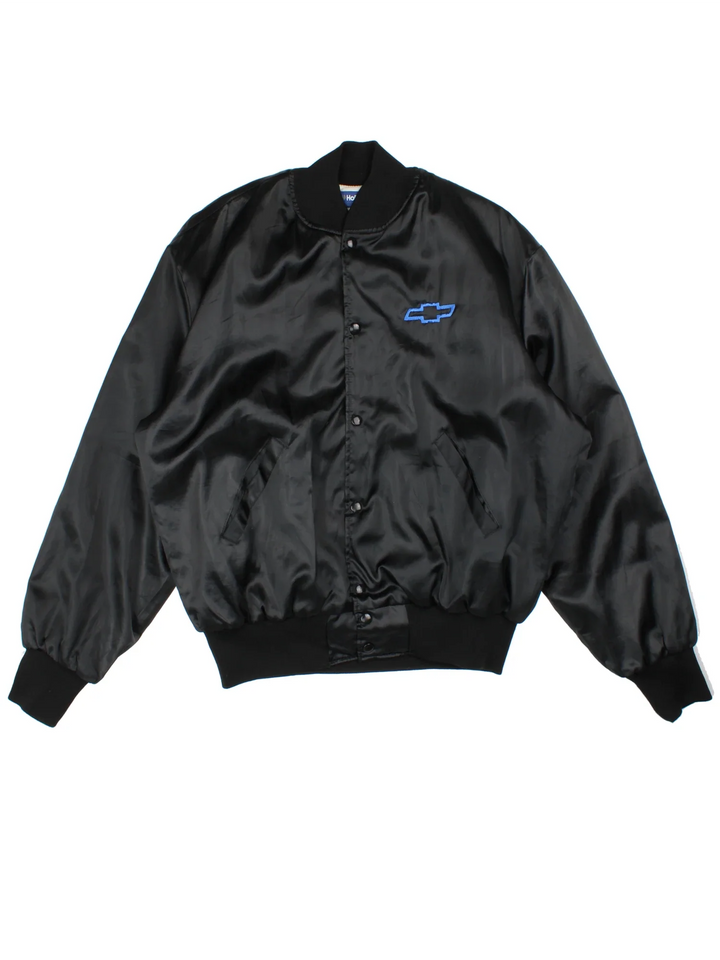 Vintage 90's Chevrolet Varsity Jacket in a black colourway. Zips up and has side pockets, and the logo embroidered on the front/back.