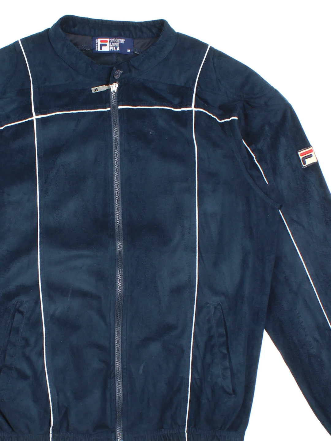 Vintage Fila Velour Track Top in a blue colourway. Zips up and has side pockets, contrast piping and logo embroidered on the sleeve
