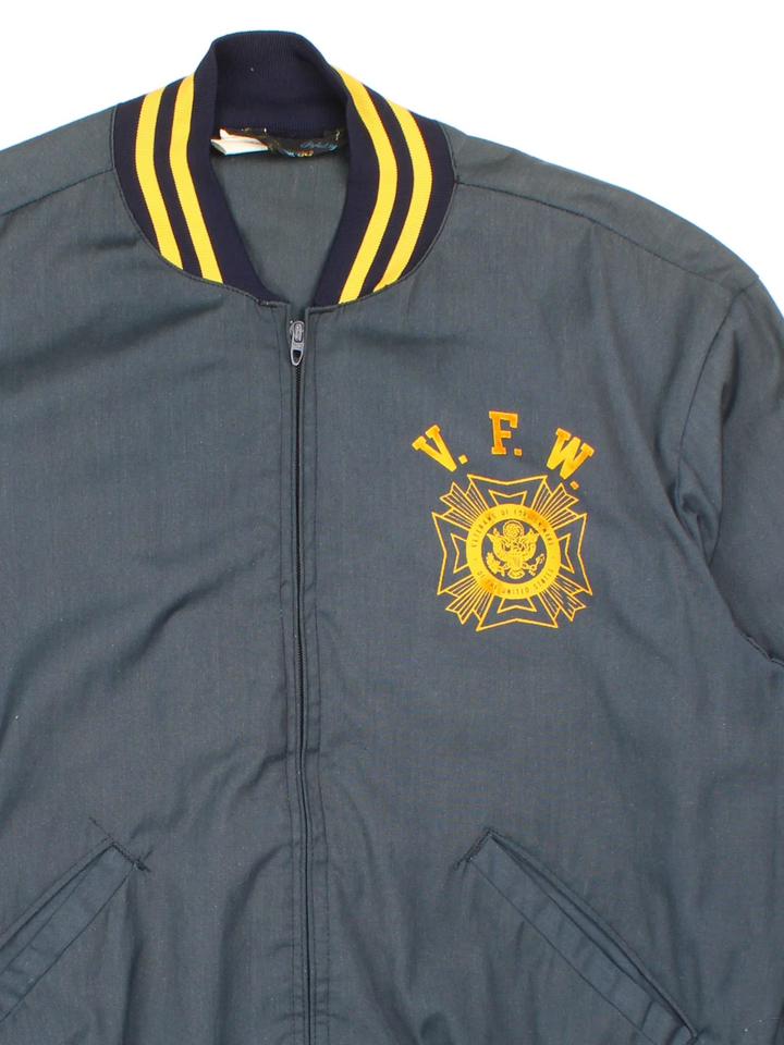 Vintage Veterans Of Foregin War Varsity Jacket in a blue colourway. Zips up and has side pockets, elasticated collar/cuffs and printed graphics on the front.