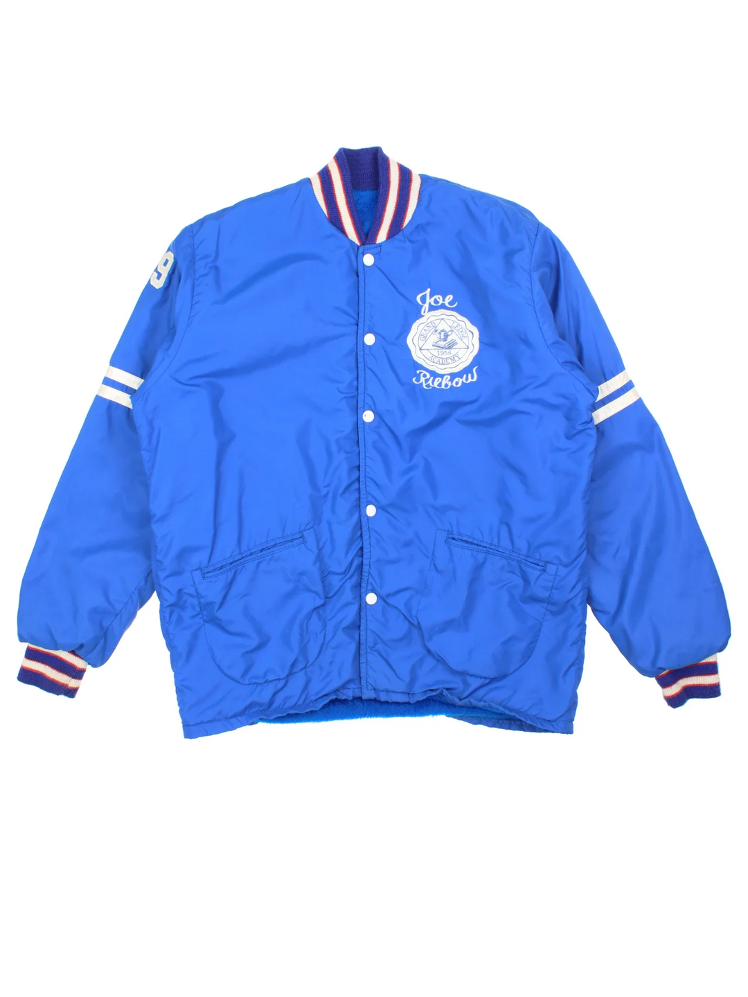 Vintage 1958 Grand Ledge Varsity Jacket in a blue colourway. Popper fastening and has side pockets, elasticated collar/cuffs and embroidered detail on the front/sleeve.