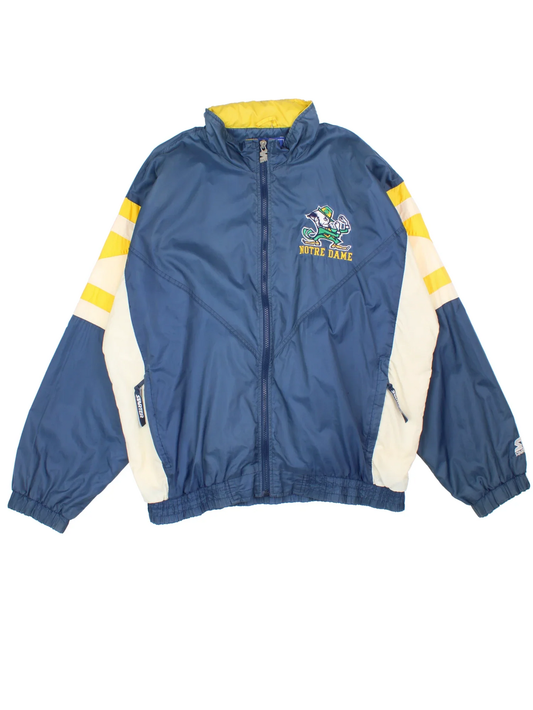 90's Starter Notre Dame Windbreaker Jacket in a blue, yellow and white colourway. Zips up and has side pockets, and has the logo embroidered on the front and spell out on the back.