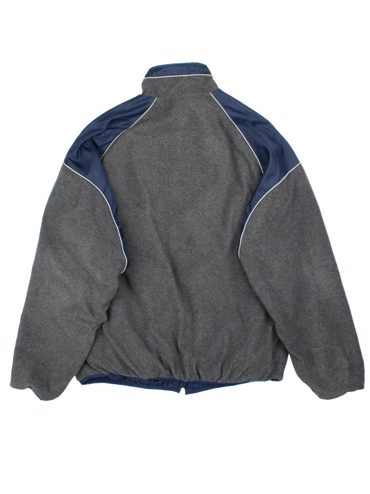New England Patriots NFL Reversible Jacket in either a blue jacket colourway or grey fleece option. Zips up and has side pockets, and has the team logo embroidered on the front and back.