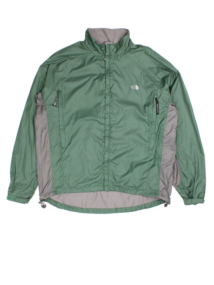 The North Face Jacket in a green colourway with grey panelling under the arm. Full zip with side pockets. Small classic logo on the front and back.