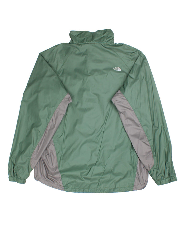 The North Face Jacket in a green colourway with grey panelling under the arm. Full zip with side pockets. Small classic logo on the front and back.