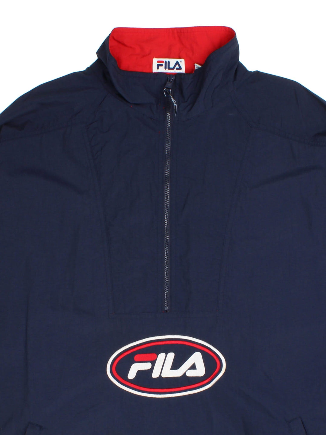 Fila 90's Windbreaker Jacket in a blue colourway with red panelling on the sleeves. Half zip with two pockets on the front and large classic logo with also a zip on the hem.