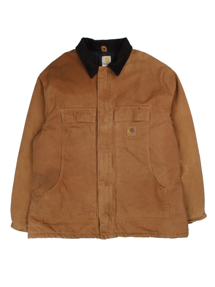 Carhartt Arctic Jacket in a brown colourway with a corduroy collar. Zips up and has multiple pockets, insulated with a quilted lining, and has the logo embroidered on the front.