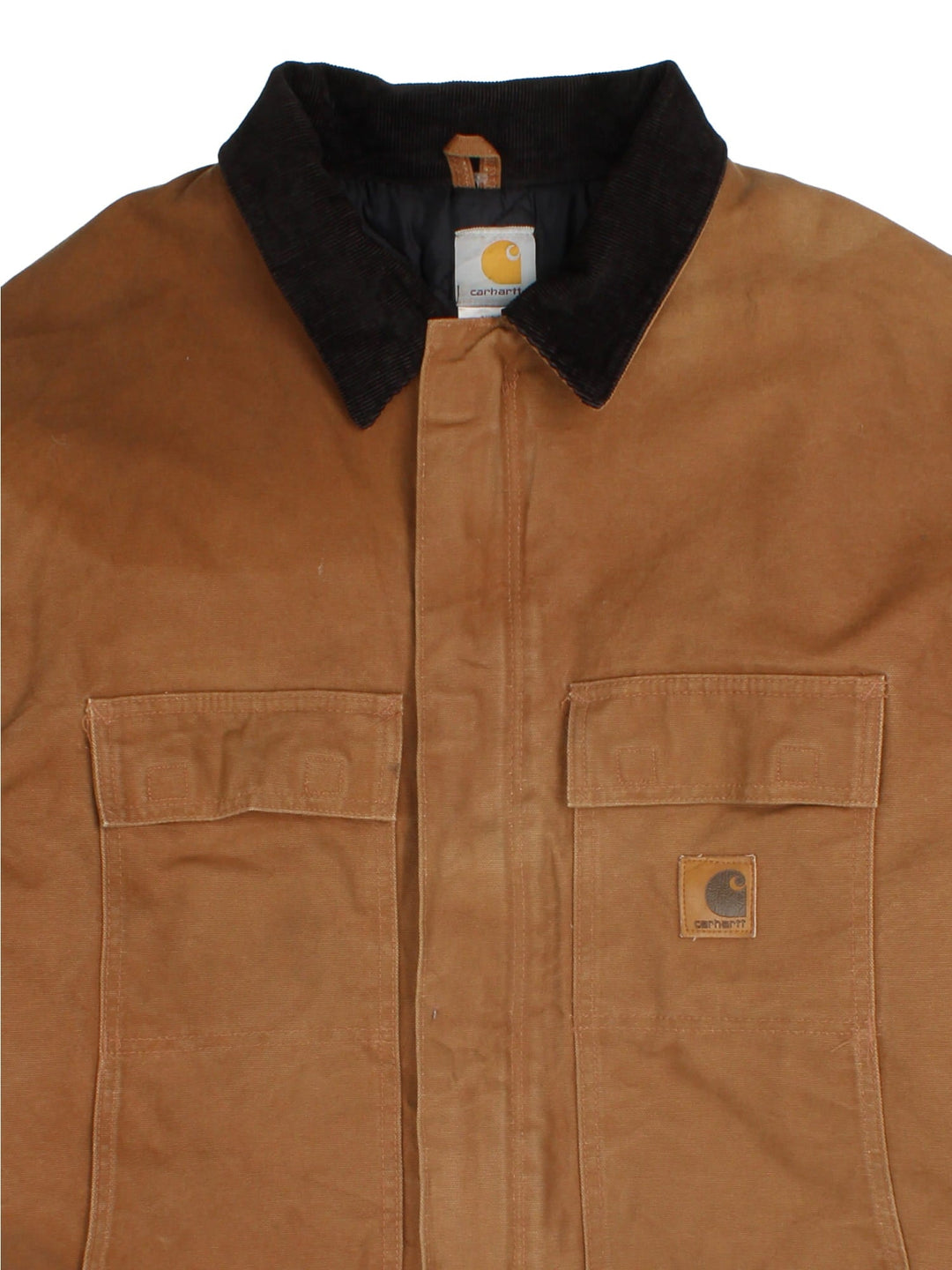 Carhartt Arctic Jacket in a brown colourway with a corduroy collar. Zips up and has multiple pockets, insulated with a quilted lining, and has the logo embroidered on the front.