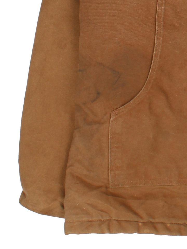 Carhartt Arctic Jacket in a brown colourway with a corduroy collar. Zips up and has multiple pockets, insulated with a quilted lining, and has the logo embroidered on the front.