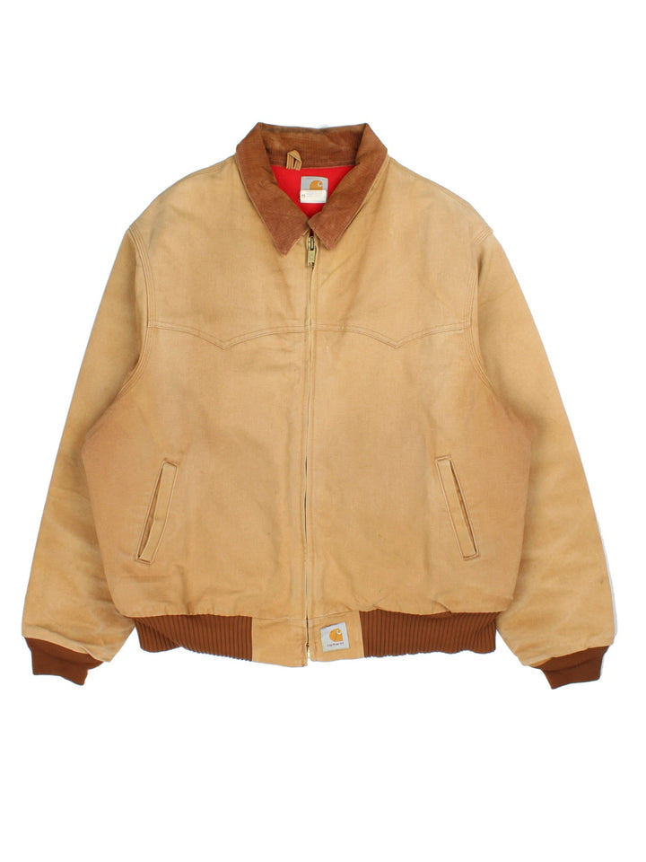 Carhartt Santa Fe Jacket in a brown colourway with a corduroy collar. Zips up and has side pockets, insulated lining, and has the logo embroidered on the front.