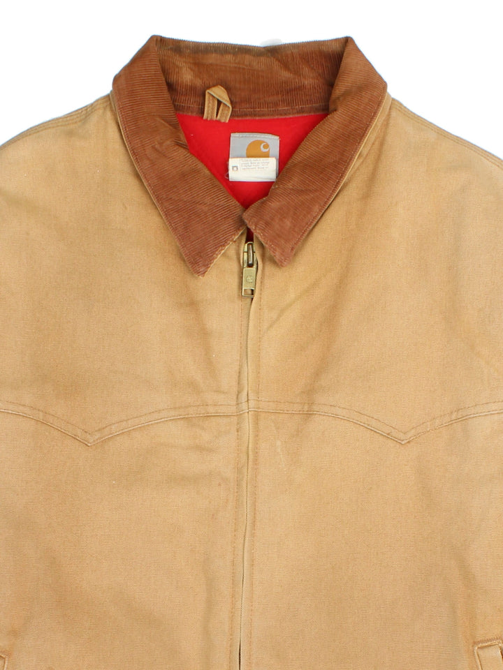 Carhartt Santa Fe Jacket in a brown colourway with a corduroy collar. Zips up and has side pockets, insulated lining, and has the logo embroidered on the front.