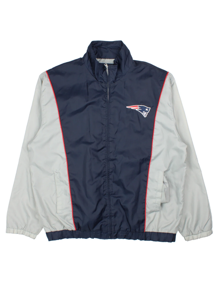 New England Patriots NFL Windbreaker Jacket in a blue colourway with grey panelling. Full zip up, multiple pockets, small logo on the front and large text logo across the back.