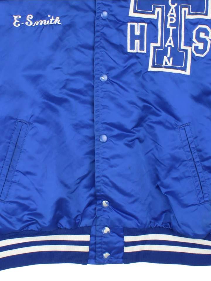 Vintage College Sports Varsity Jacket in a blue colourway with white detailing. Full button up, team logo on the front and larger graphic logo across the back.